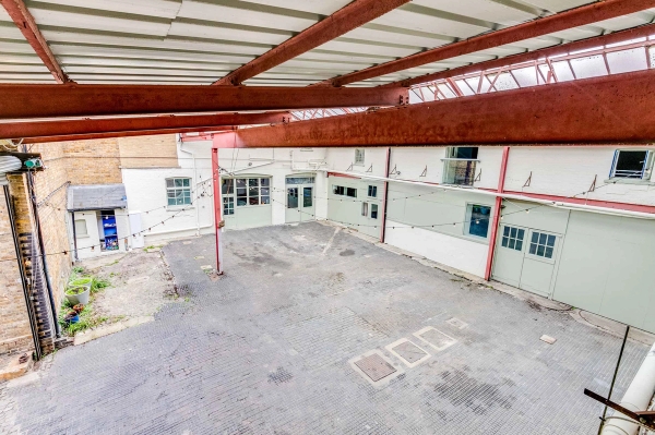 Versatile warehouse venue yard with abundant natural daylight for film crews and photography, managed by Love Locations TW10.