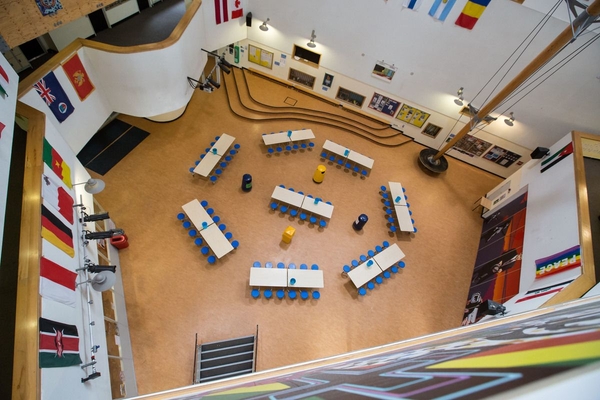 Love Locations school dining hall shoot space Bristol BS7: Top-down vertical view of study tables arranged in a central atrium, excellent for institutional student lifestyle photography and film sets.