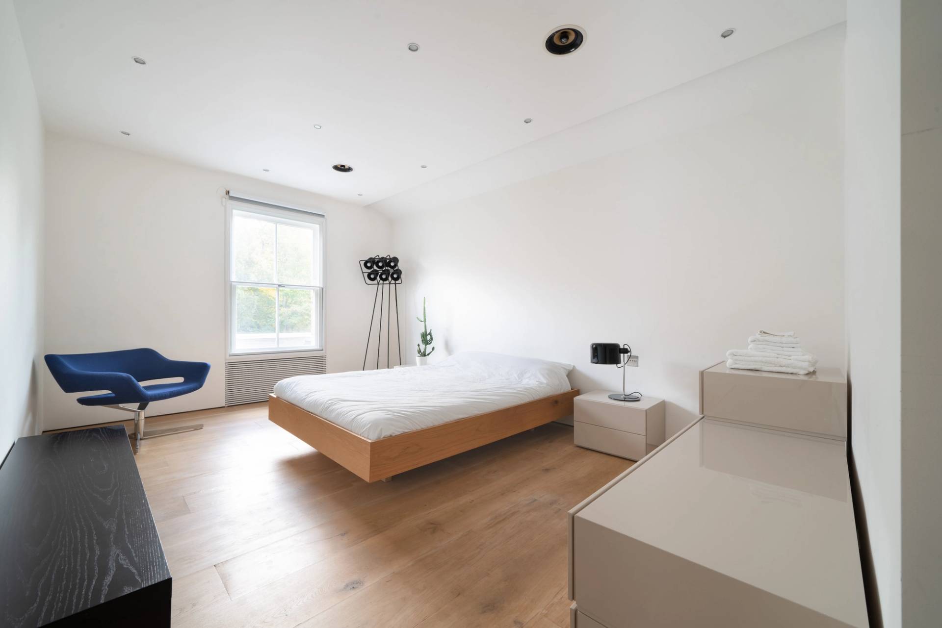 Private subterranean home gym facility with commercial workout equipment, power rack, and rubber flooring, Love Locations SW6.