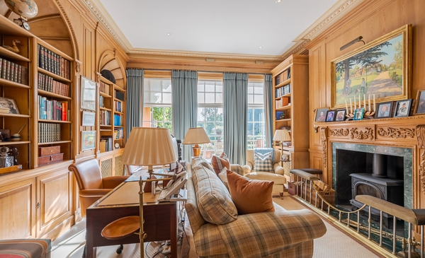 Principal bedroom suite with dual aspect garden views.