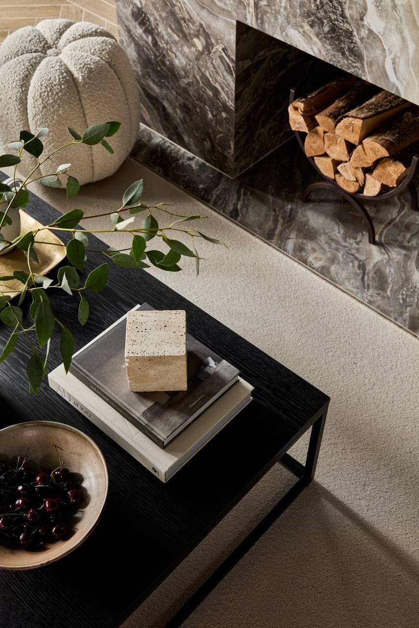 Meticulously styled black coffee table showcase featuring hardback books, marble trays, and fresh botanicals, ideal for interior styling features, Love Locations WD23.