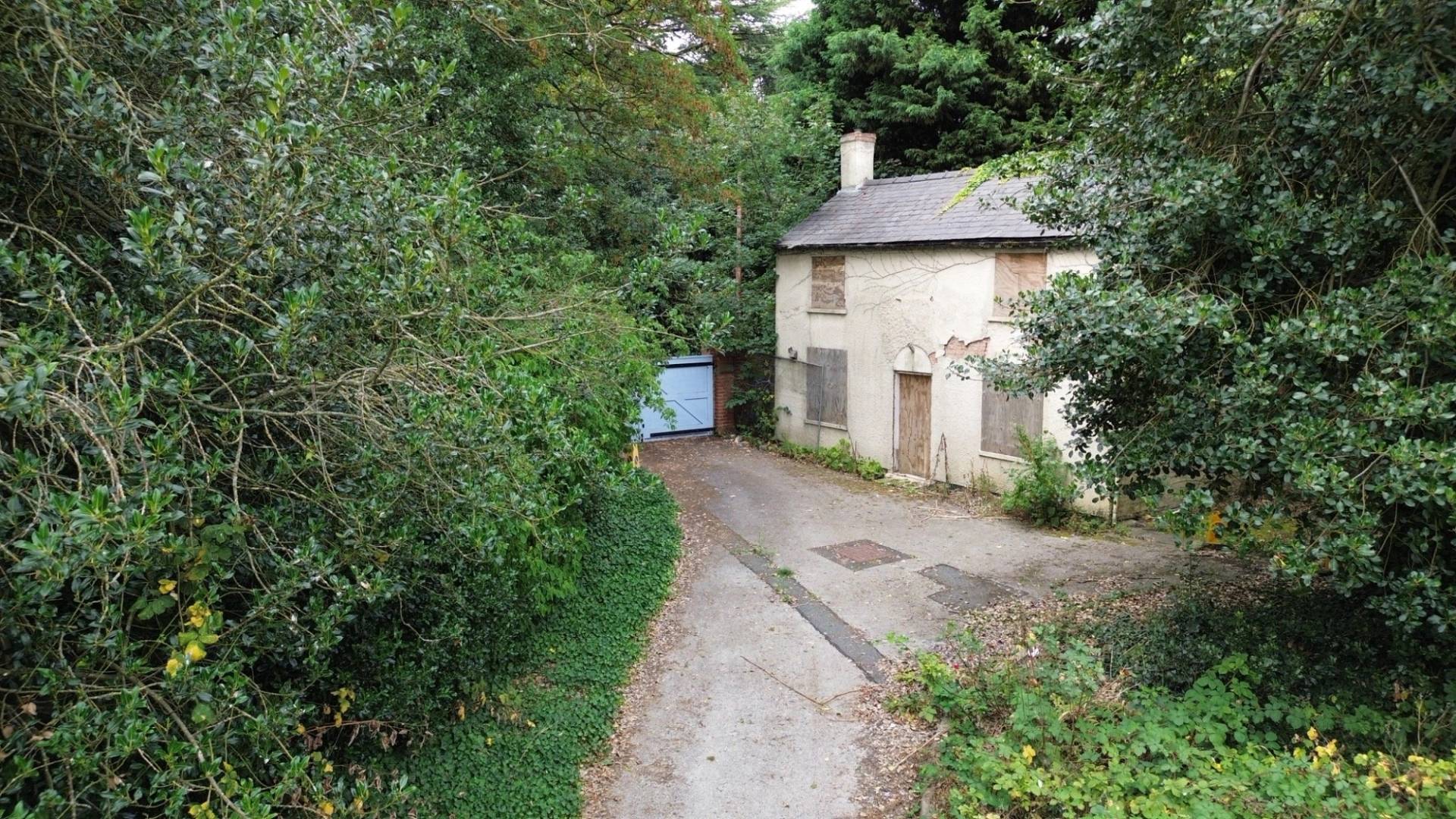Private driveway leading to a boarded-up, abandoned Victorian cottage in Beeston, Nottinghamshire, available for media hire through Love Locations.