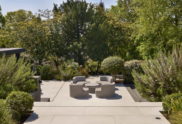 Sleek sunken outdoor terrace with contemporary curved lounge seating, premium garden location via Love Locations.