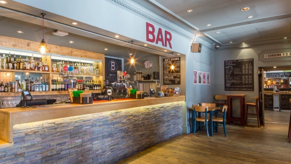 Close-up view of the warm ambient illuminated bar counter and spirits display at The Ritzy Cafe shoot location in Brixton SW2 from Love Locations.