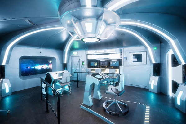 Immersive sci-fi control room location space with interactive glowing consoles and captain's deck layout, listed by Love Locations.