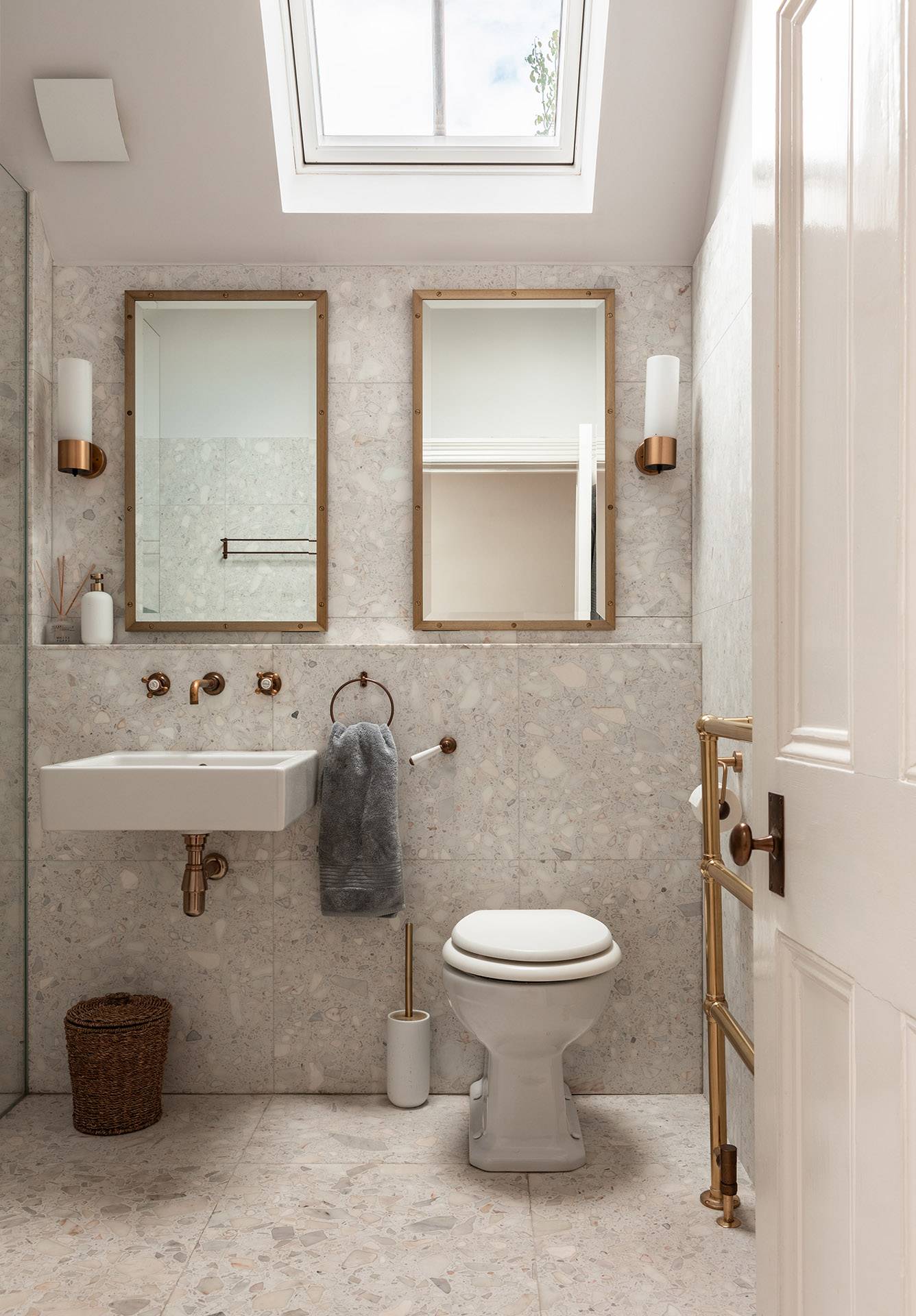 Luxury terrazzo tiled bathroom location featuring dual wall-mounted mirrors and brass tapware, ideal for skincare brand commercials via Love Locations.