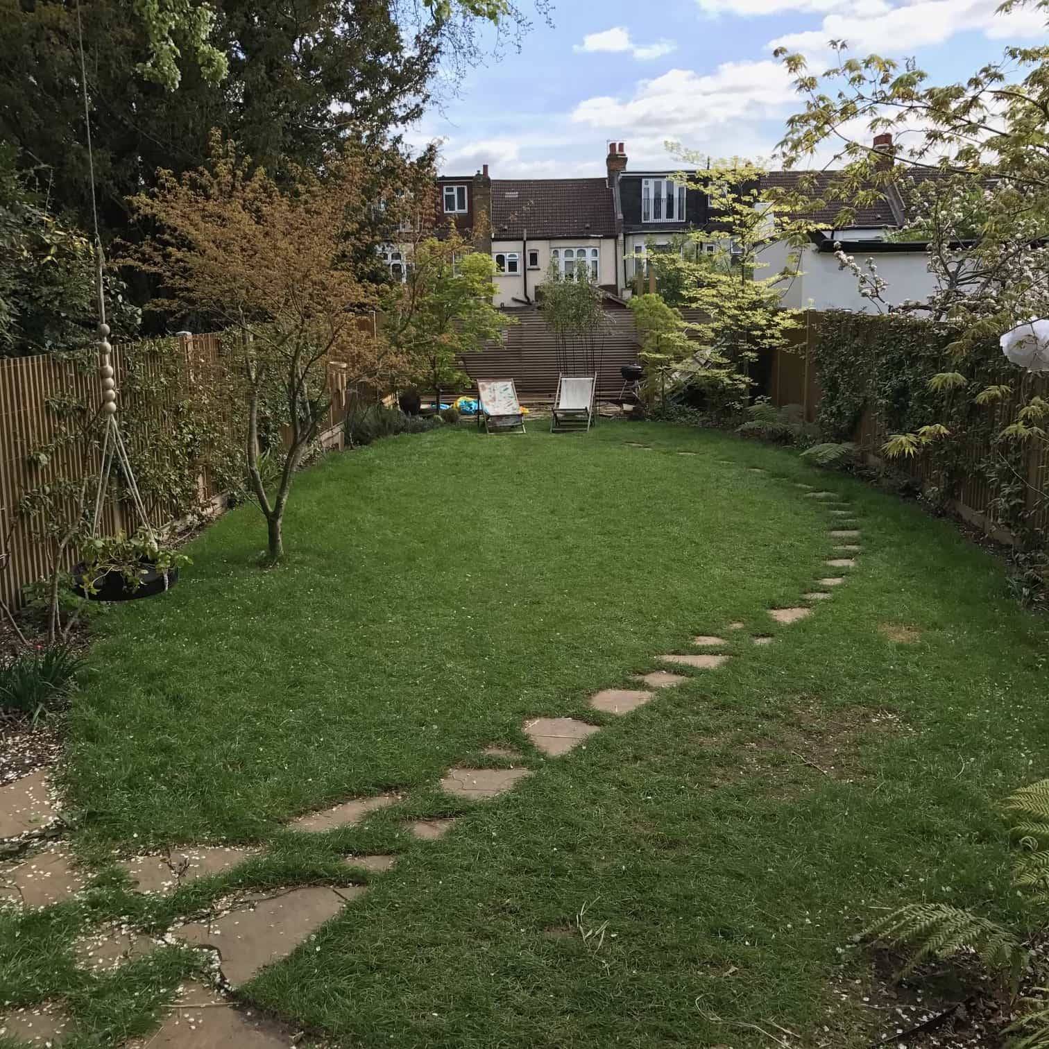 Spacious green garden lawn with stepping stone path and mature trees in Palmers Green, Love Locations N13.