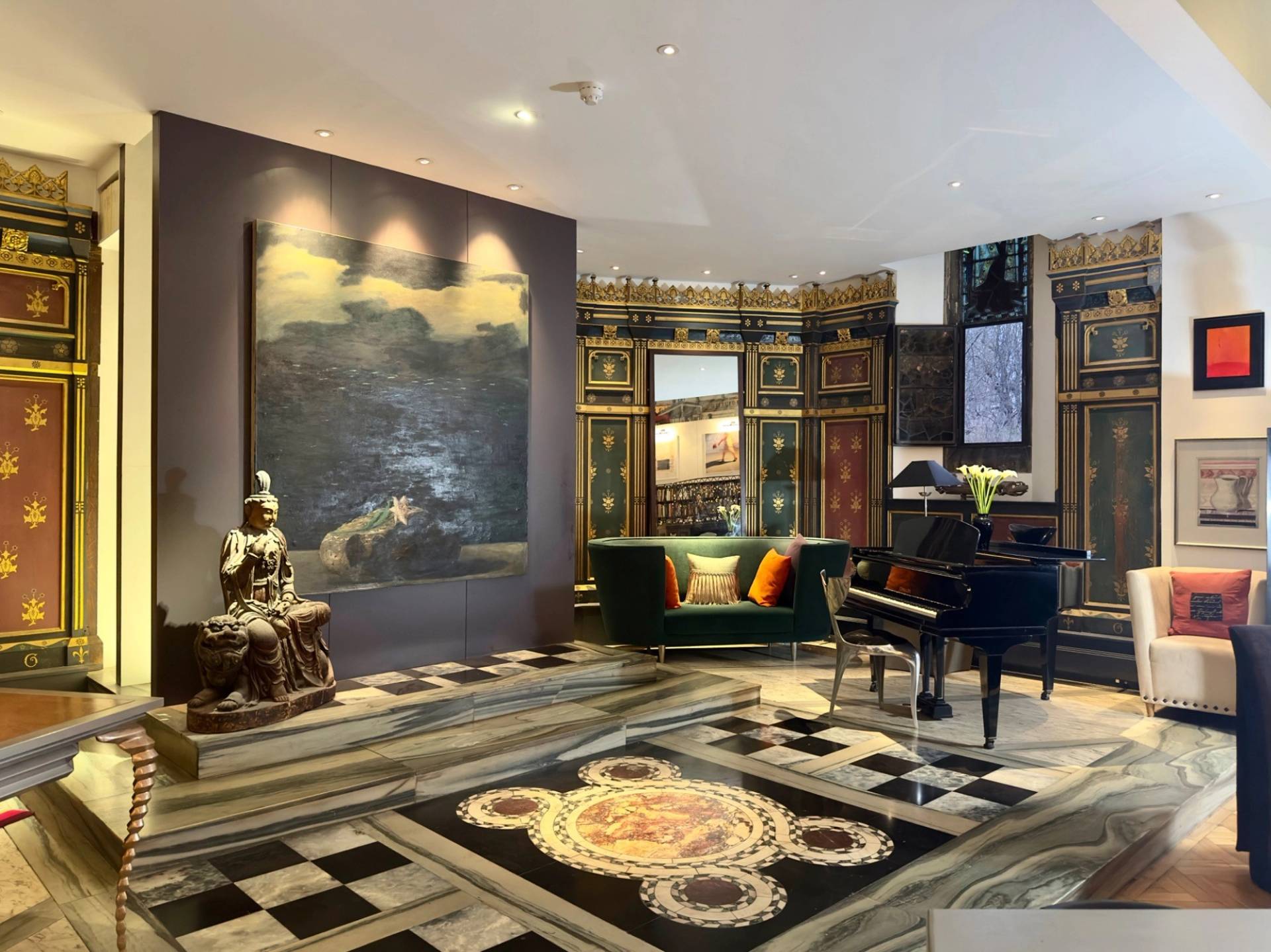 Dramatic interior corner featuring a large wall mural, grand piano, and black-and-white tiled floor in Oval SE5 by Love Locations.
