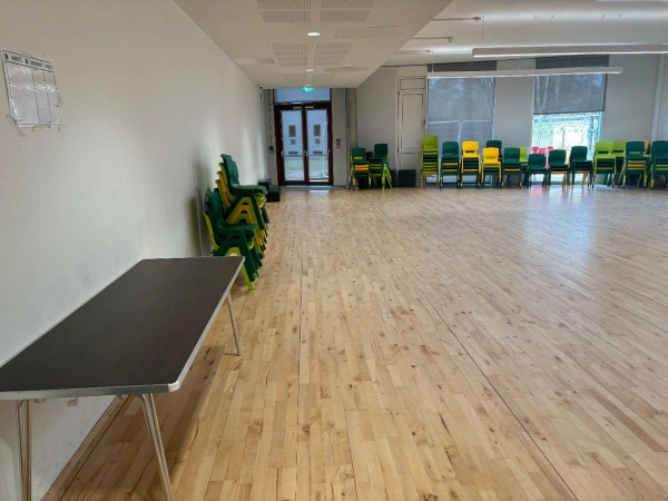 Spacious school assembly hall or multi-purpose studio with polished wood flooring for media hire, curated by Love Locations.