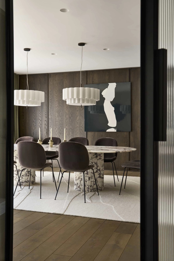 Sophisticated formal dining room location with dark timber panelling and a sculptural marble table, Love Locations.