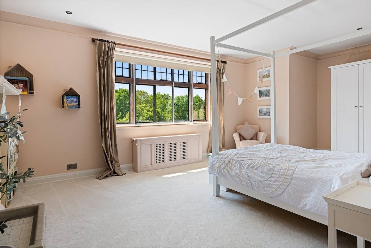 Four-poster bed detail set against leaded windows in a light-filled master bedroom, Love Locations RH13.