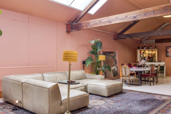 Eclectic warehouse conversion location space featuring statement lighting and warm coral-pink interiors, Love Locations London.