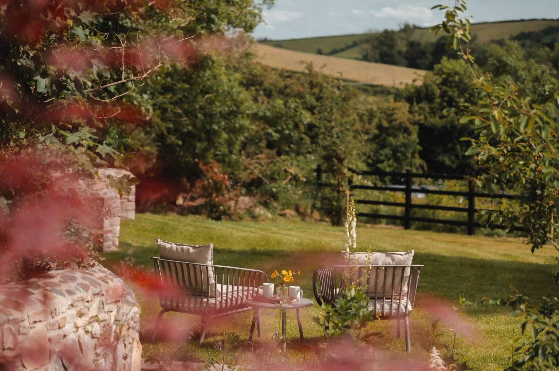 Outdoor garden seating area surrounded by lush green foliage in Castleblayney County Monaghan Ireland from Love Locations.