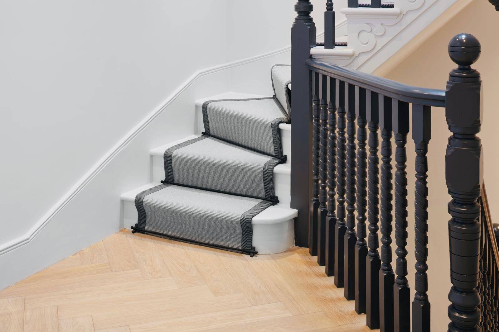 Staircase landing detail showing grey carpet runner on light timber steps and dark balustrade, Love Locations TW11.