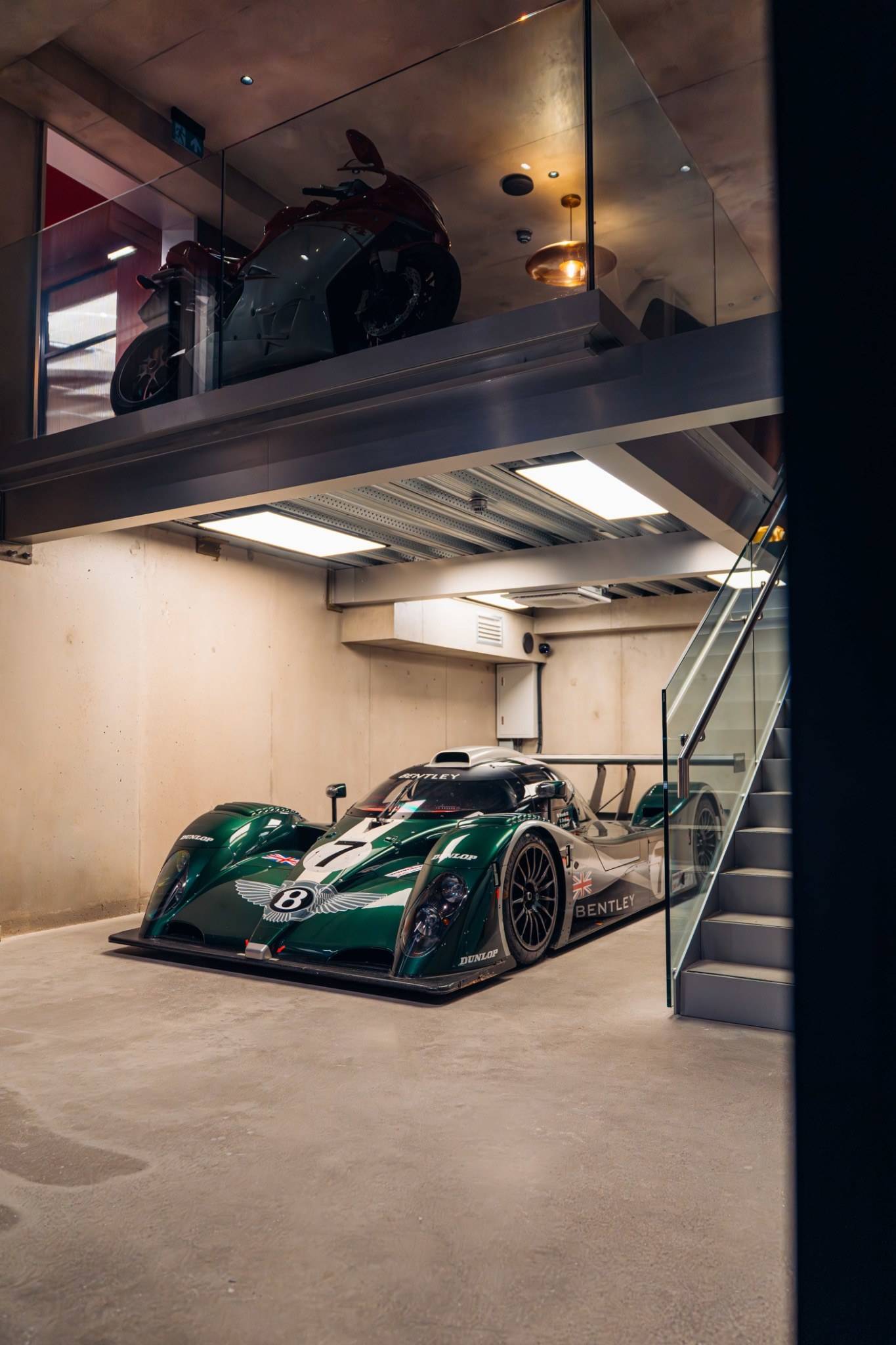 Classic green race car under warm recessed lighting in a commercial venue in Brentford TW8 by Love Locations.