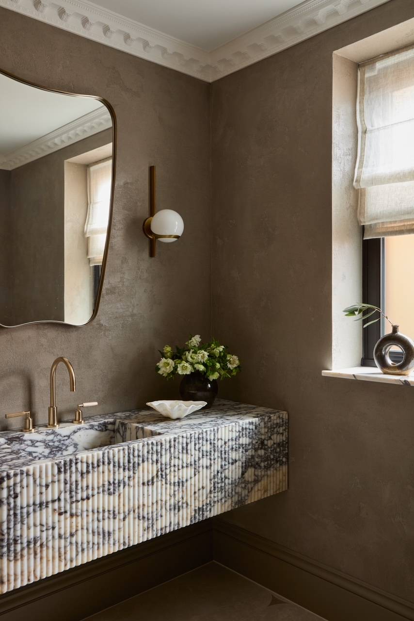 Close-up of an artisan blue marble floating sink block paired with premium gold tapware, suitable for architectural detail photography, Love Locations WD23.