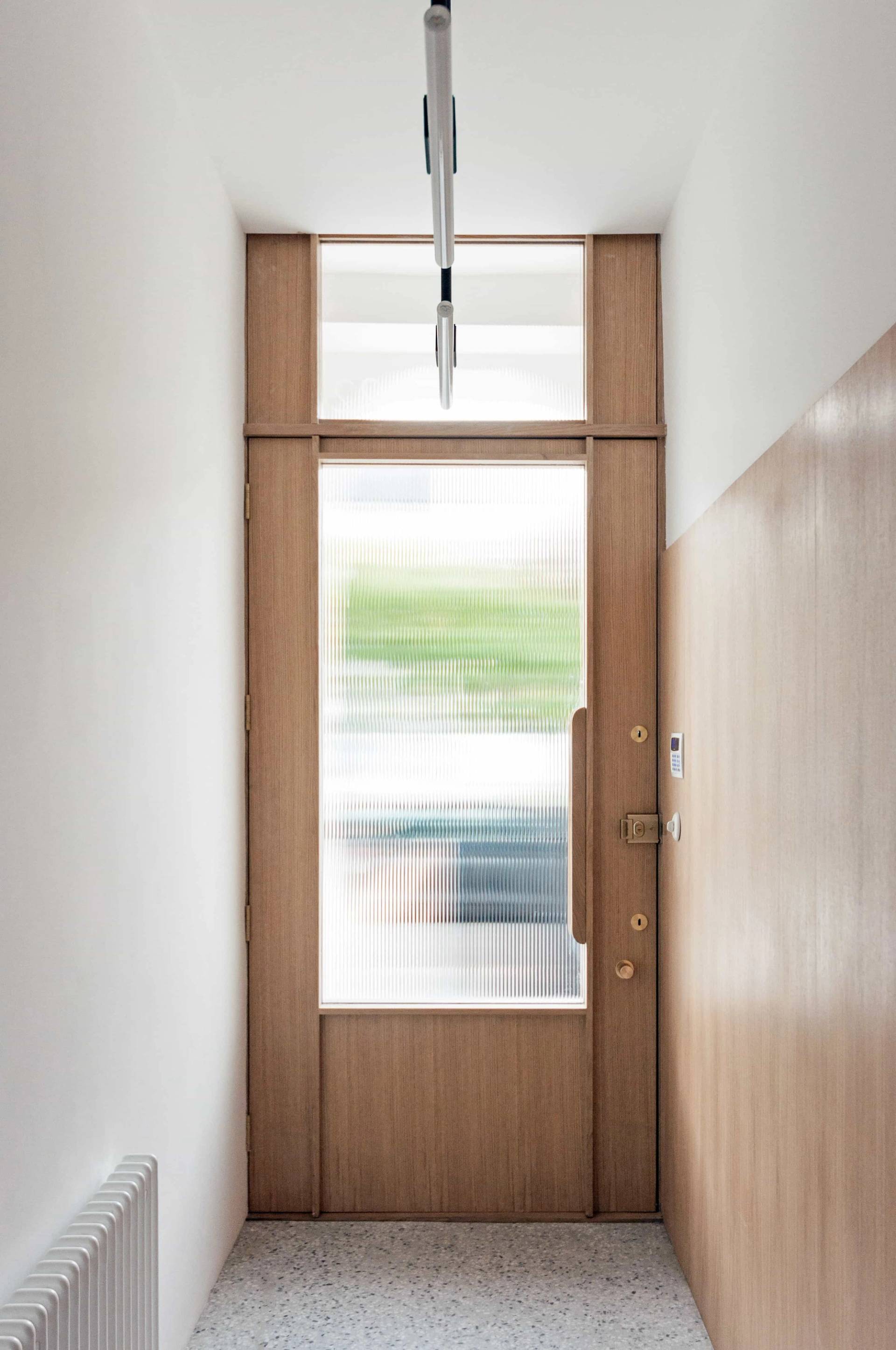 Bespoke timber front entry door and frosted glass side window feature in Hackney N16 by Love Locations.