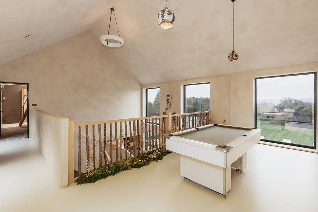 Pitched ceiling games mezzanine featuring a pool table and natural timber post balustrades, Love Locations GU32.