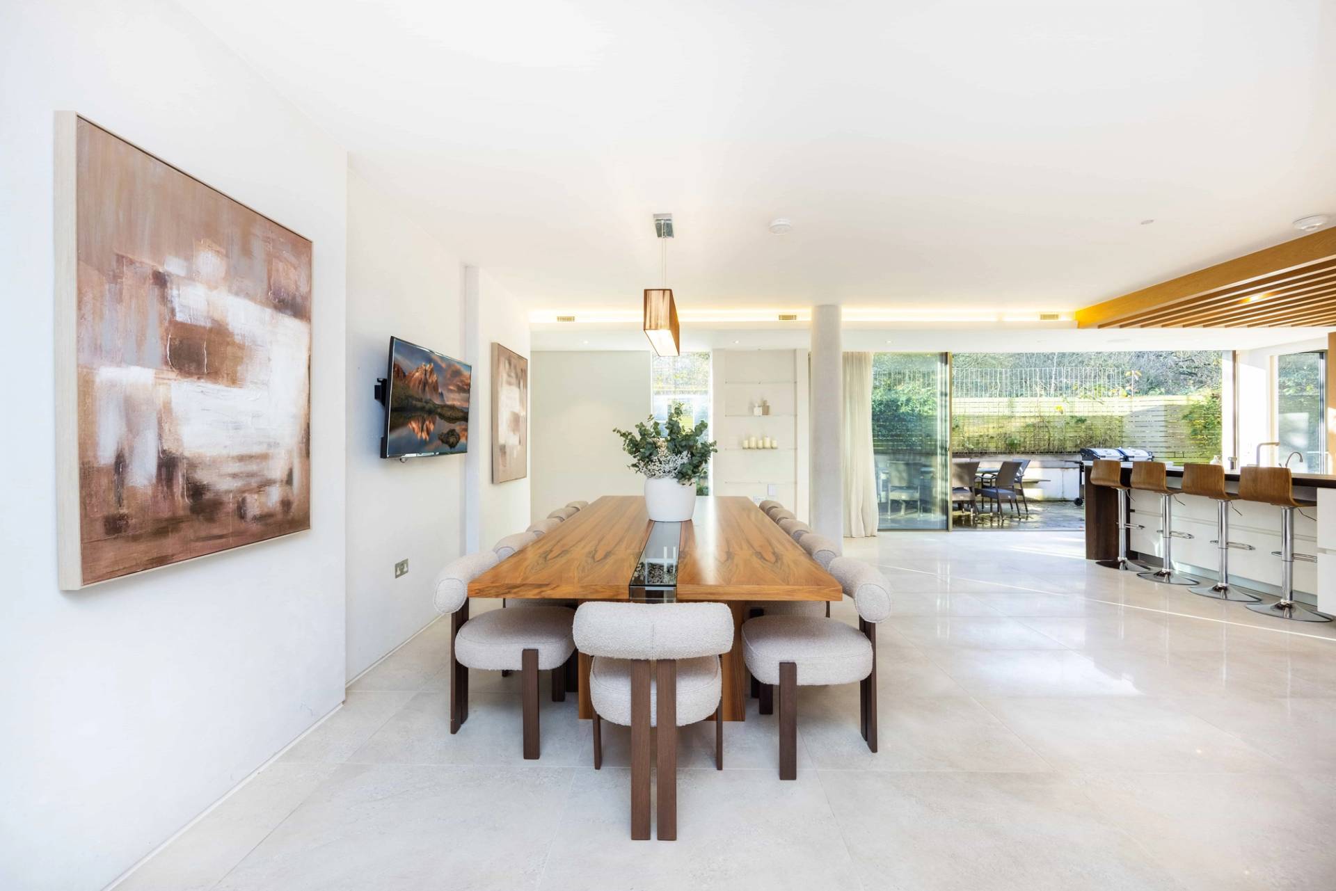 Open-plan dining room transition view looking towards garden sliding glass doors, Love Locations WD7.