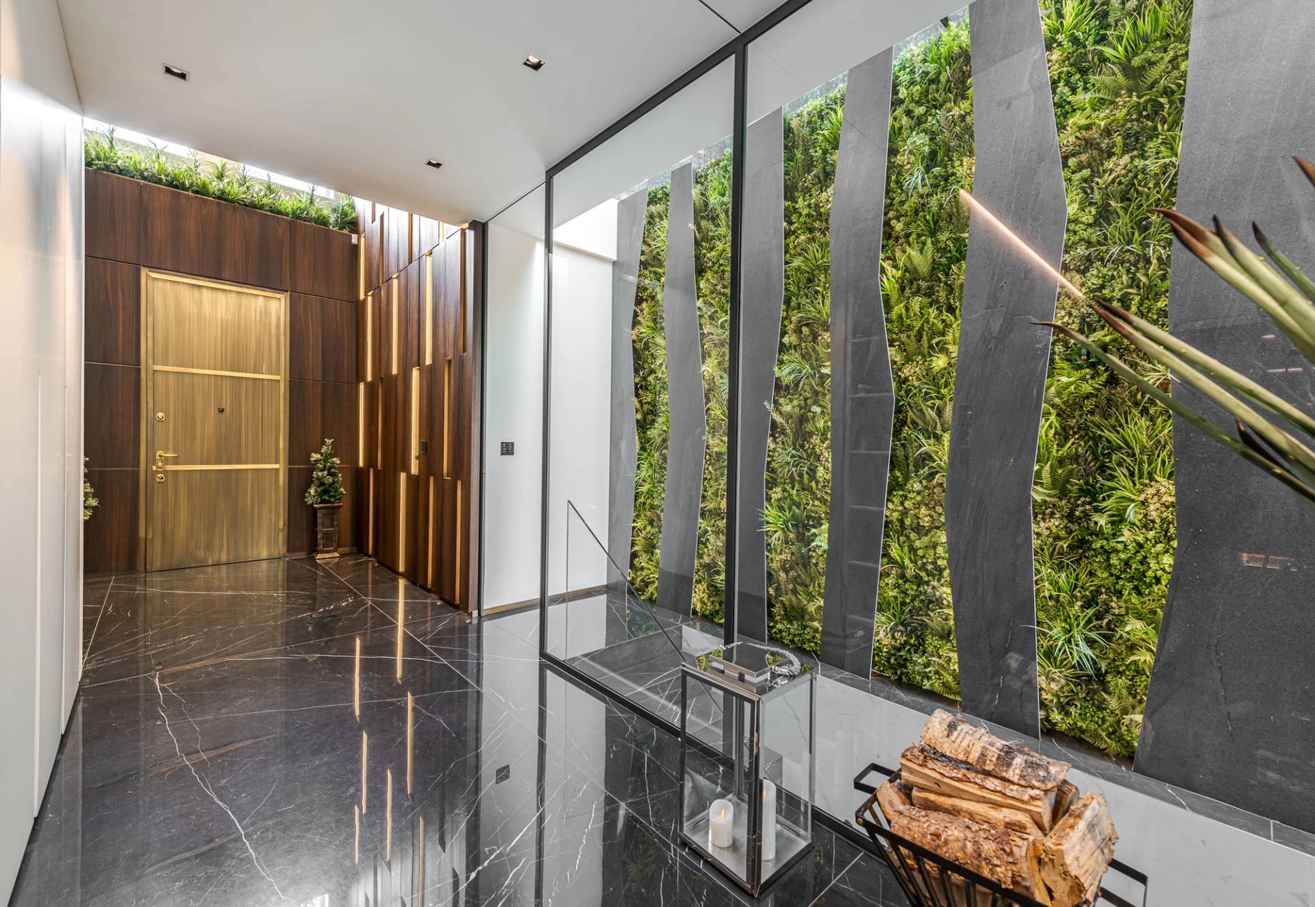 Indoor vertical green wall garden installation set beside black marble tiled floors, Love Locations SW11.