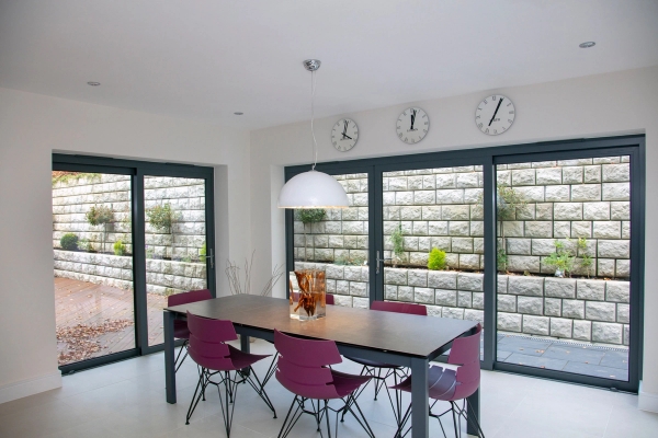Minimalist dining table set looking out onto a tiered stone patio wall, premium residential shoot space for homeware brand campaigns, Love Locations.
