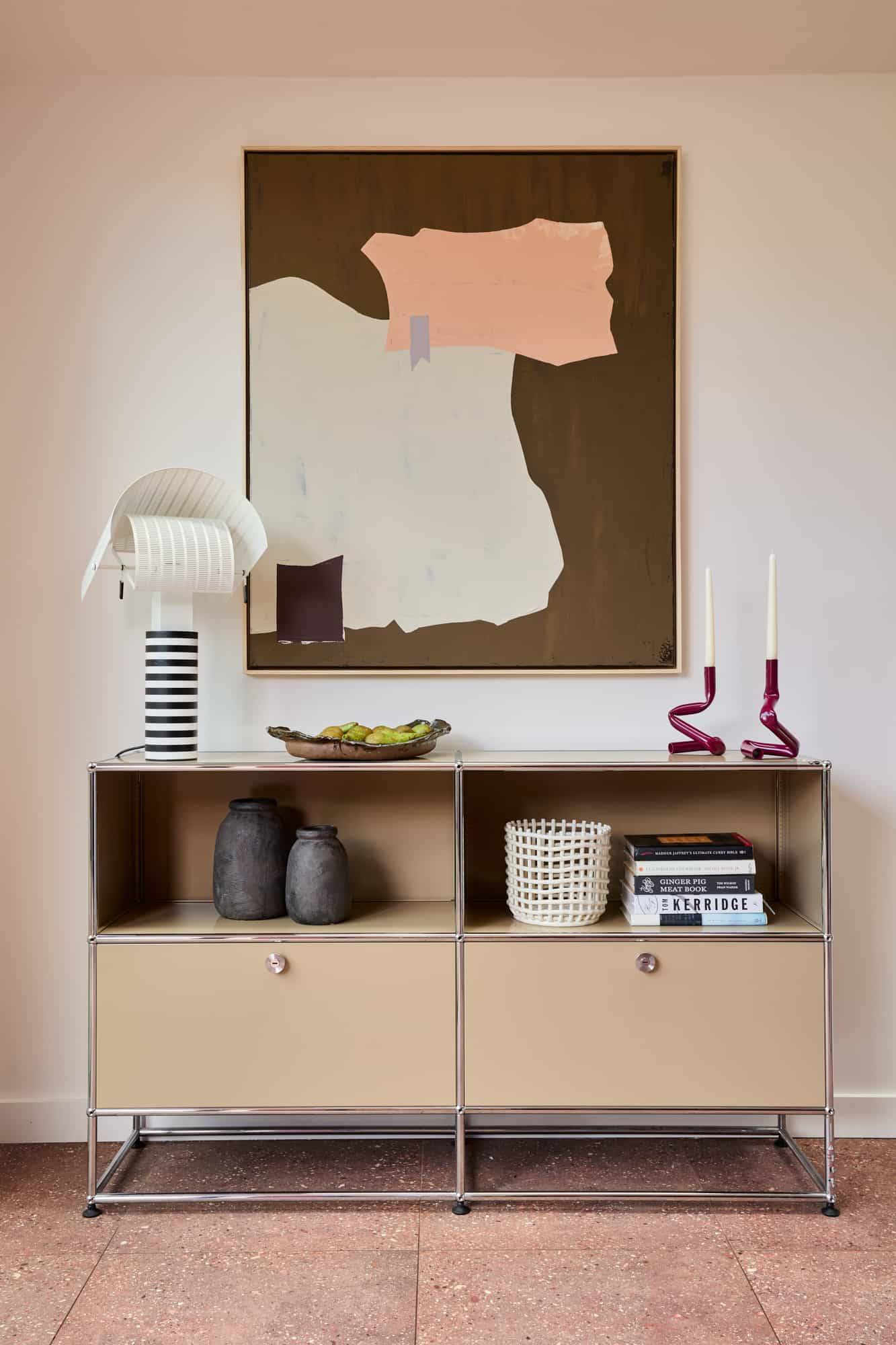 Love Locations minimalist interior backdrop SE23: Elegant low-slung console table paired with a large neutral abstract canvas mural, a clean setting for fashion portrait shoots.