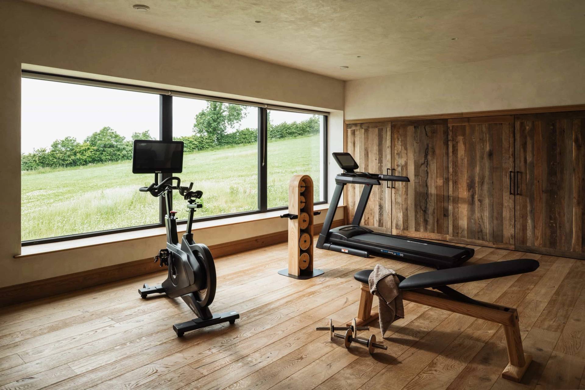 Commercial gym shoot space in Castleblayney County Monaghan Ireland by Love Locations, highlighting exercise bikes, treadmills, and floor-to-ceiling landscape windows.