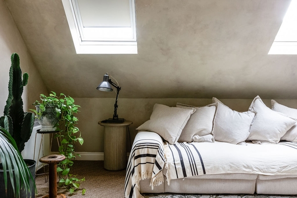 Cosy loft bedroom with skylight and neutral interiors at Love Locations house location in Liss, Hampshire GU33.