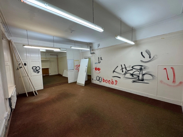 Gritty urban location room covered in black spray paint graffiti inside an unmodernised mansion property, through Love Locations.