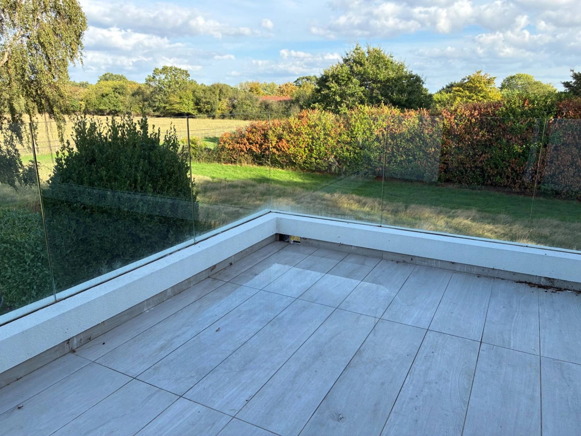 Private balcony deck overlooking countryside fields from a bedroom shoot location in Essex CM4, curated by Love Locations.