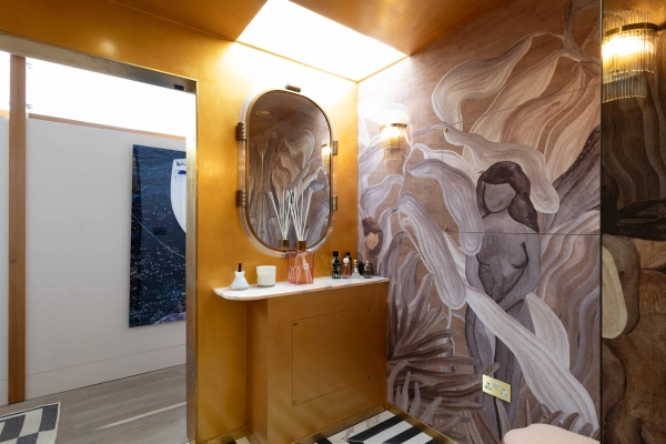 Love Locations dramatic bathroom location Godalming: Luxury powder room showing full shimmering gold leaf walls and a bespoke organic-shaped vanity mirror, ideal for beauty ads.