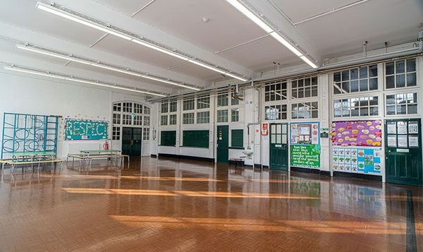 Bright institutional interior setting with reflective timber floors, ideal for commercial brand shoots via Love Locations Finsbury Park.