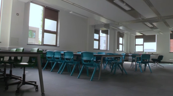 Love Locations modern science laboratory RG30: Adaptable classroom space featuring high laboratory benches and teal stools, perfect for secondary school scenes in films and television.