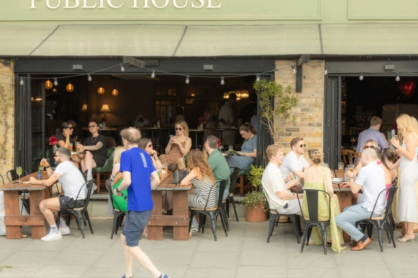 Lively outdoor terrace seating and patio dining area at a restaurant shoot location on Streatham Hill, South West London SW16, showing an open storefront layout with customers, perfect for casual dining lifestyle commercials and British high-street brand advertising via Love Locations.