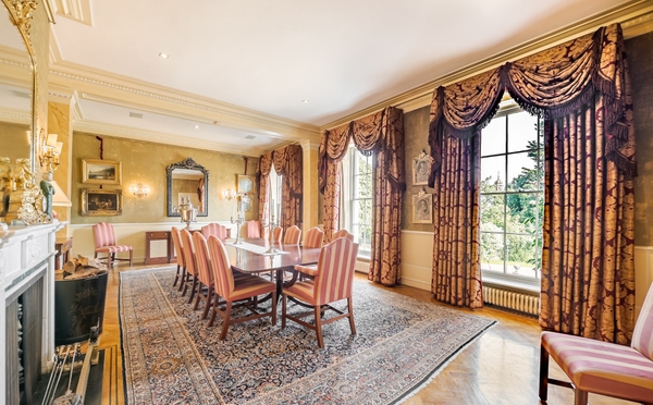 Stone fireplace surround in a traditional sitting room.
