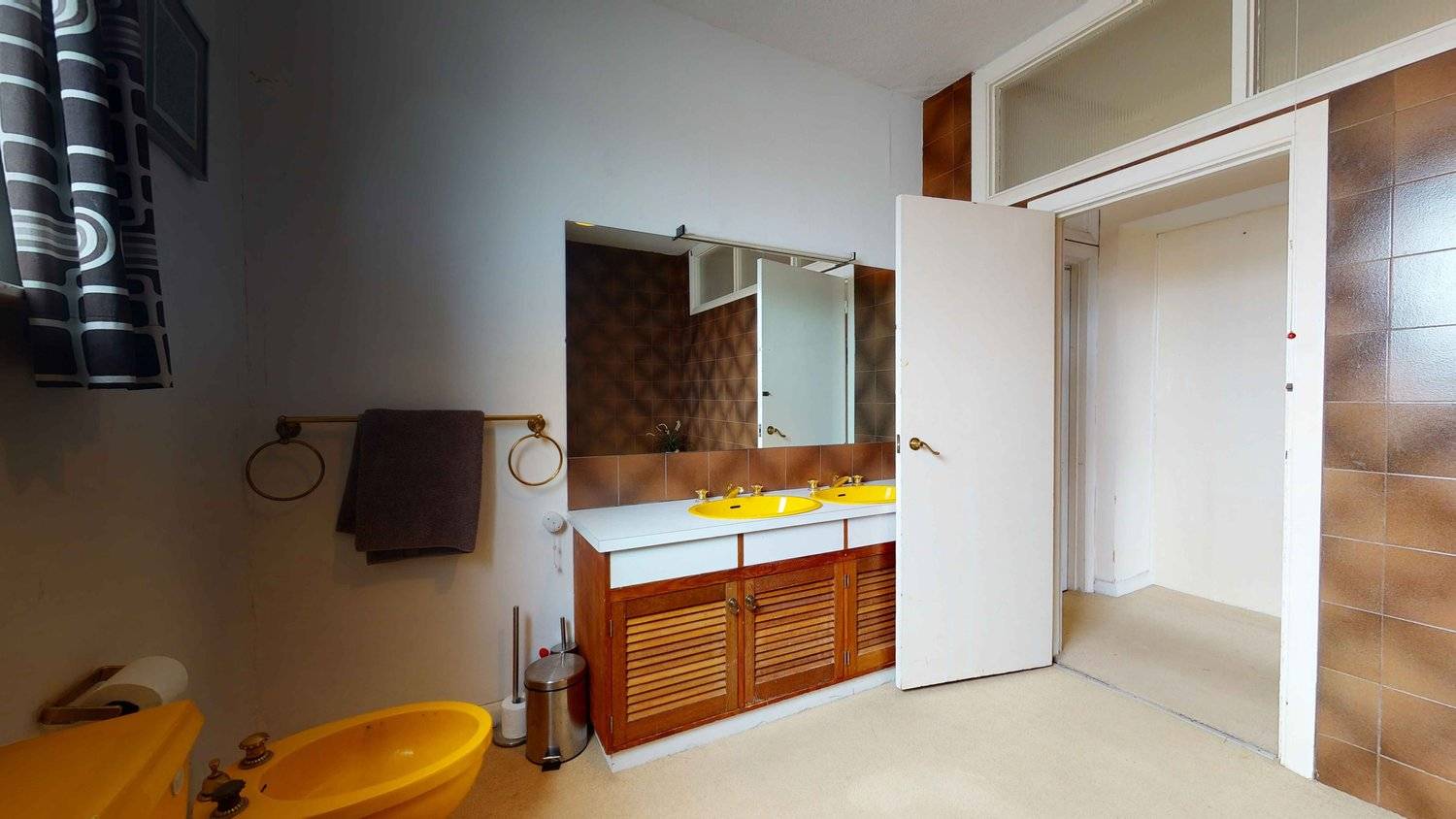 Retro bathroom vanity unit featuring twin yellow sinks, wood louvre doors, and large wall mirror, ideal for beauty editorials, Love Locations SW16.