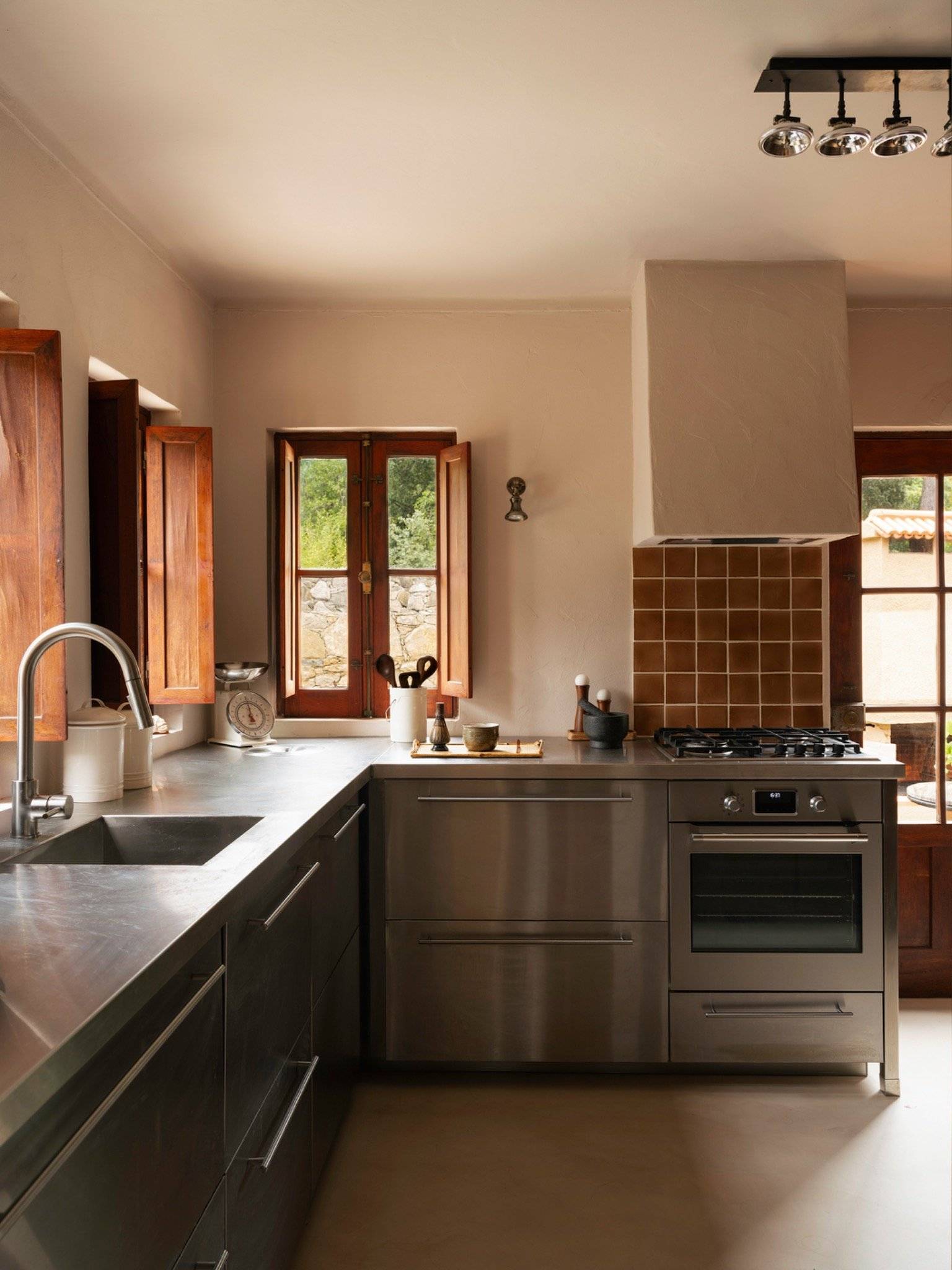 Stainless steel modern kitchen with tiled splashback, timber windows, and open shelving for food shoots, Love Locations 2705-064.