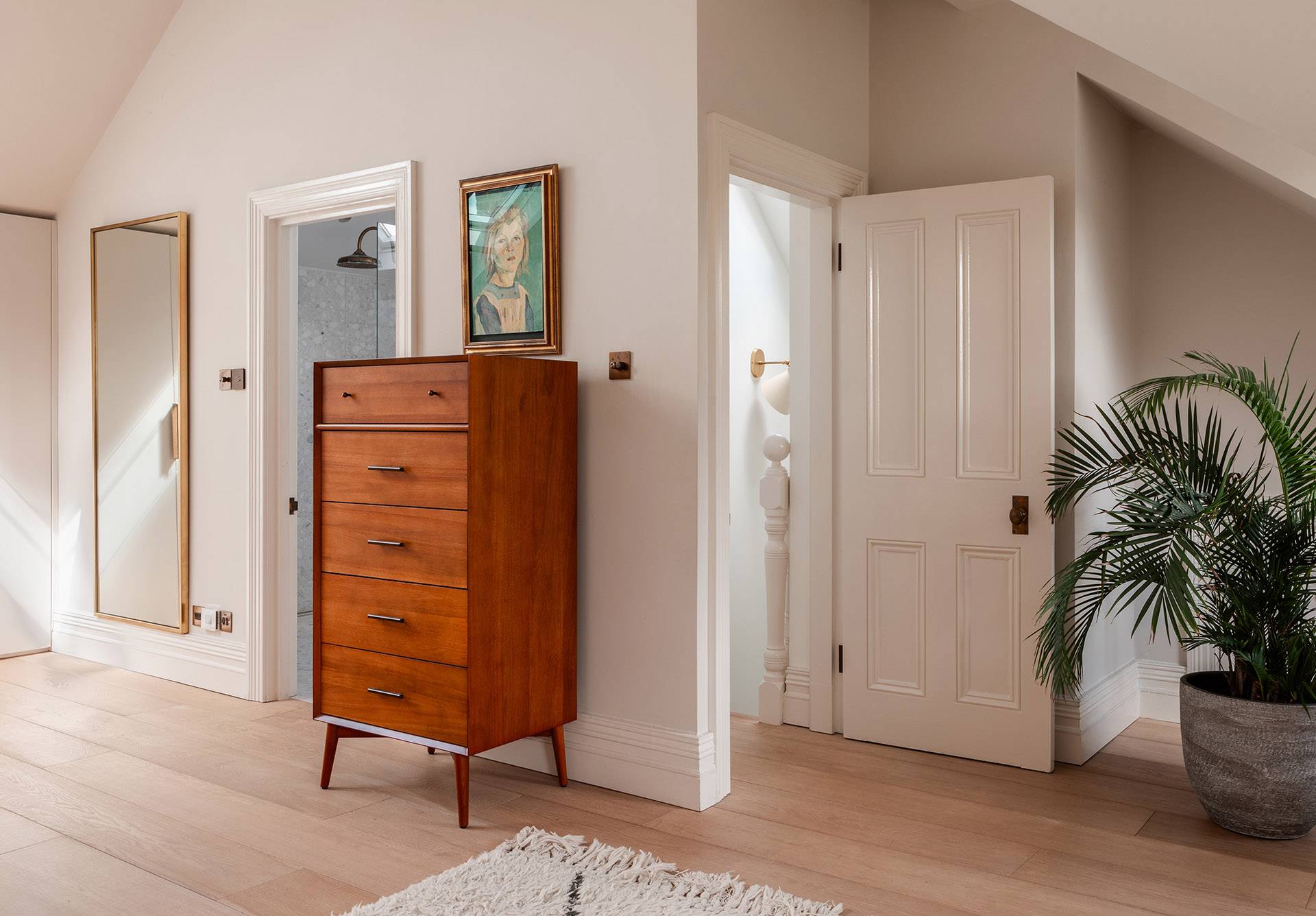 Attic bedroom landing transition showing opening doors into an ensuite bathroom, Love Locations.