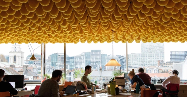 Bright creative office space with floor-to-ceiling windows and textured orange ceiling in Whitechapel London E1 – love locations