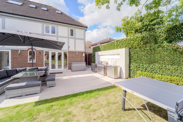 Paved outdoor terrace with table tennis table set outside a detached mansion facade, Love Locations RM11.