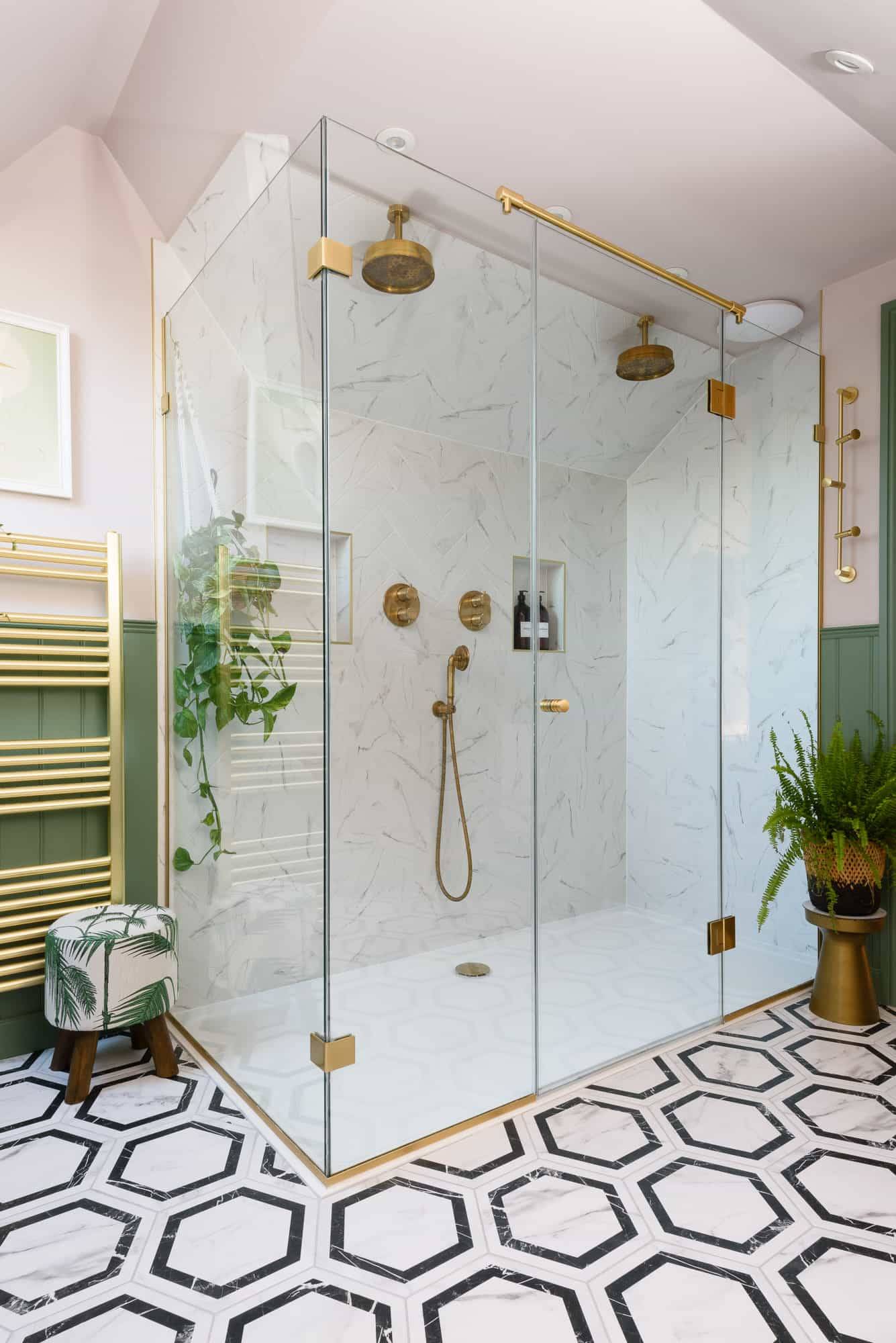 Double walk-in wet room shower featuring marble wall tiles, brass showerheads, and geometric floor tiles, Love Locations TW11.