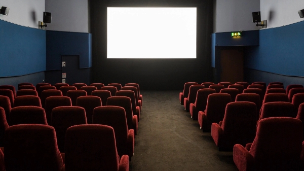 Direct view from the seating area looking up at the illuminated blank white cinema screen at The Ritzy Screen 3 in Brixton SW2, available for production hire through Love Locations.