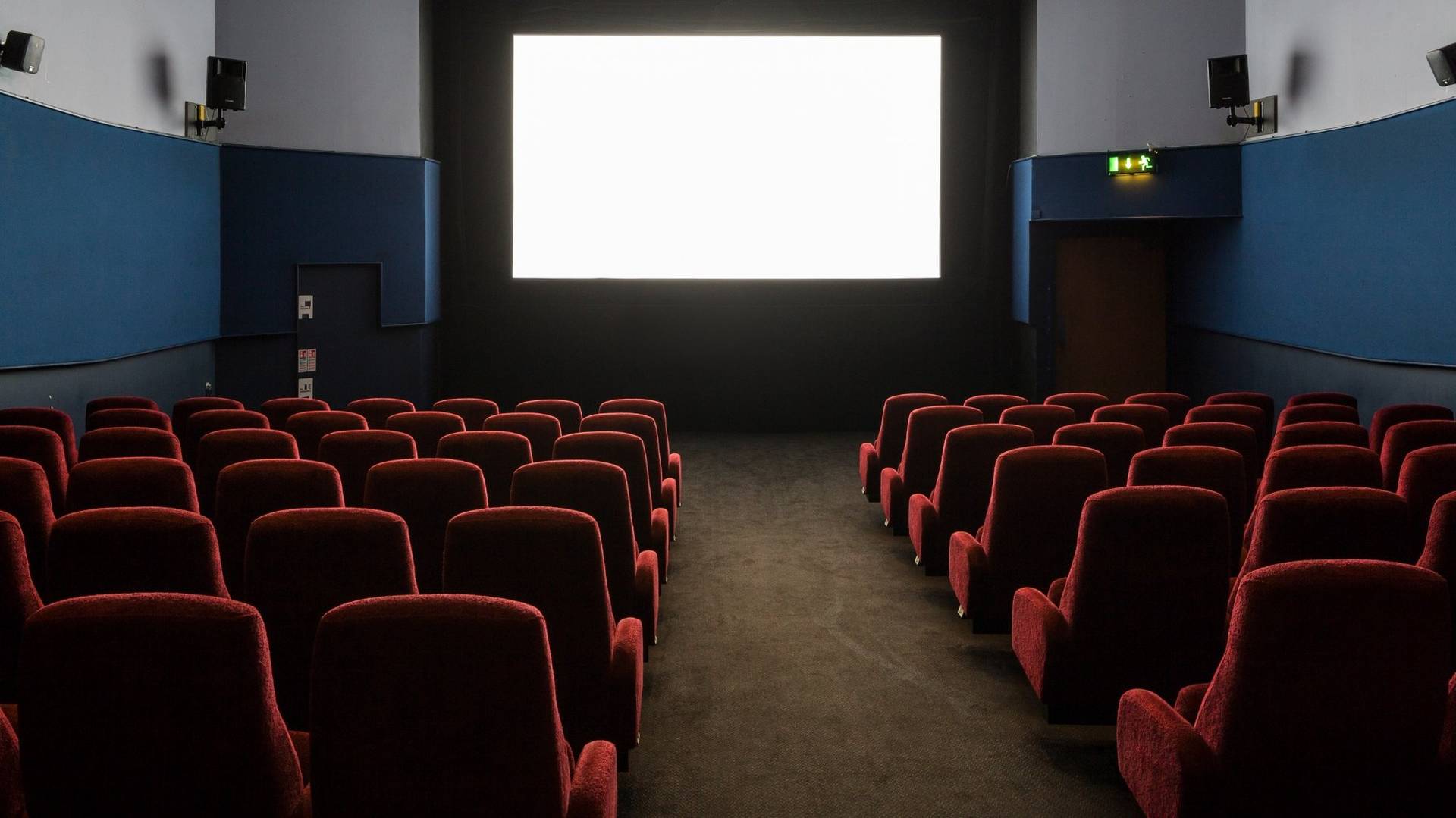 Direct view from the seating area looking up at the illuminated blank white cinema screen at The Ritzy Screen 3 in Brixton SW2, available for production hire through Love Locations.