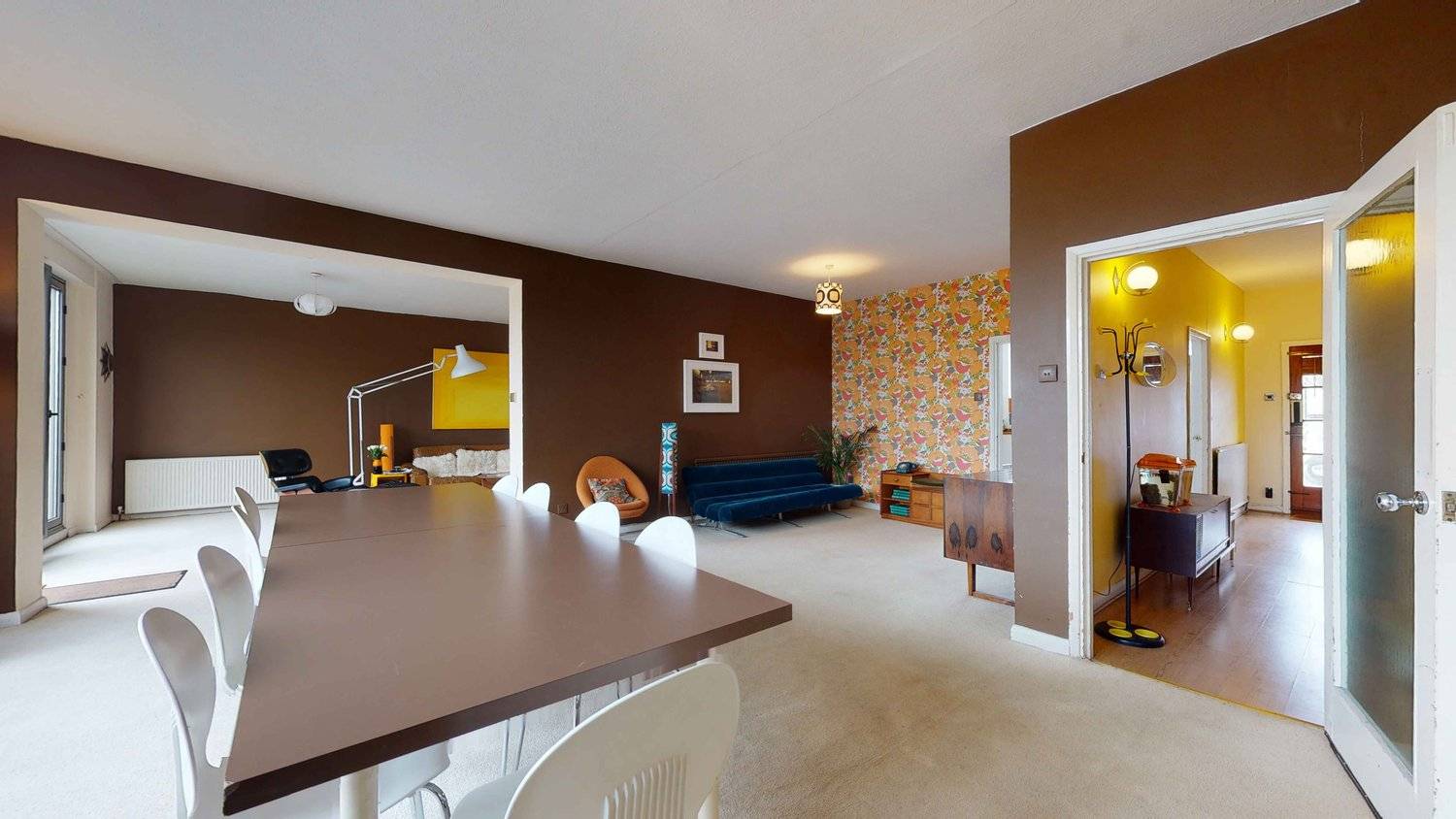 Mid-century open-plan reception room view looking from the dining area into a retro lounge, Love Locations SW16.