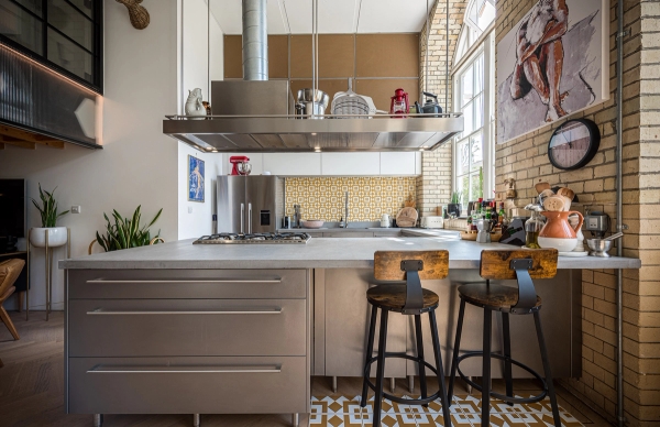 High-end kitchen island unit with bar stools under industrial extraction hoods for cooking shoots, Love Locations London Bridge.