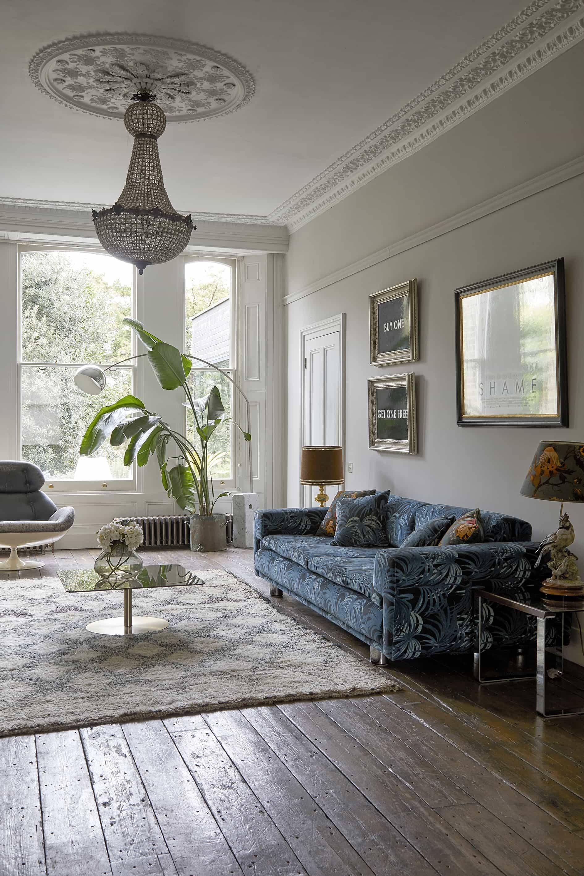 Blue patterned sofa set under framed art prints cast in natural window light, ideal for homeware campaigns, Love Locations N16.