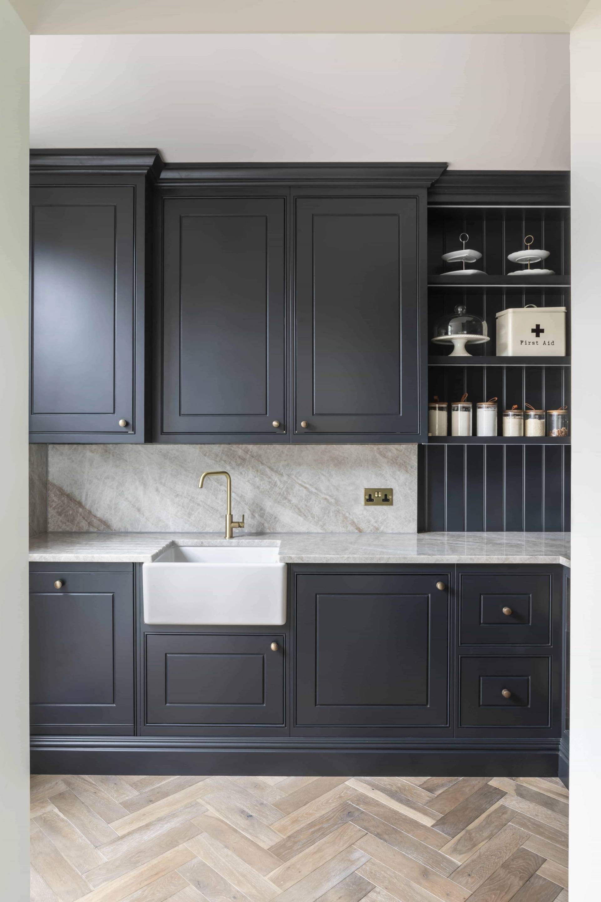 Dark charcoal shaker pantry cabinets with a white butler sink and marble splashback in Buckinghamshire, Love Locations HP18.