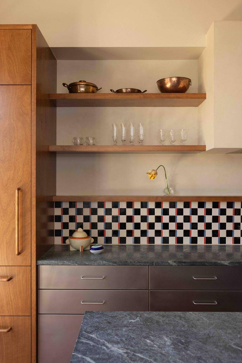 Close-up detail of a modern kitchen coffee bar and pantry storage in a Boerum Hill townhouse location hire through Love Locations, featuring black and white checkerboard tiles and dark stone countertops.