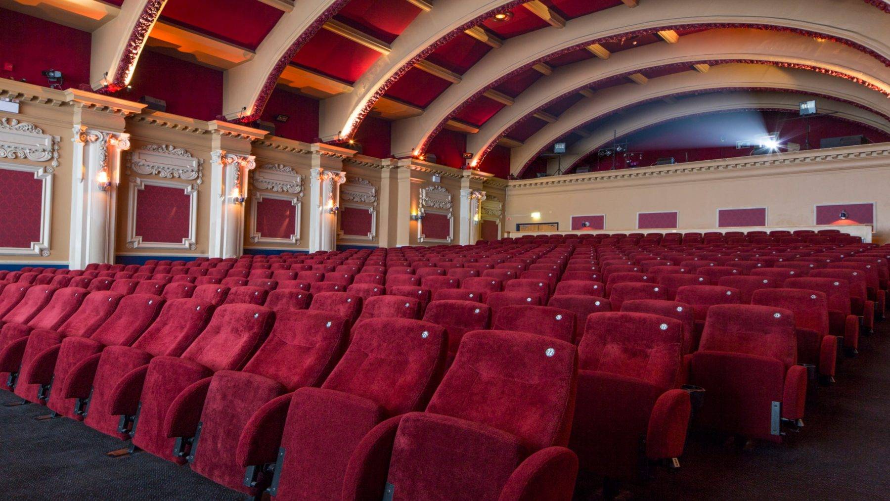 Looking up from the front row seats toward the tiered auditorium seating and ornate vaulted ceiling details inside The Ritzy Screen 1 via Love Locations.