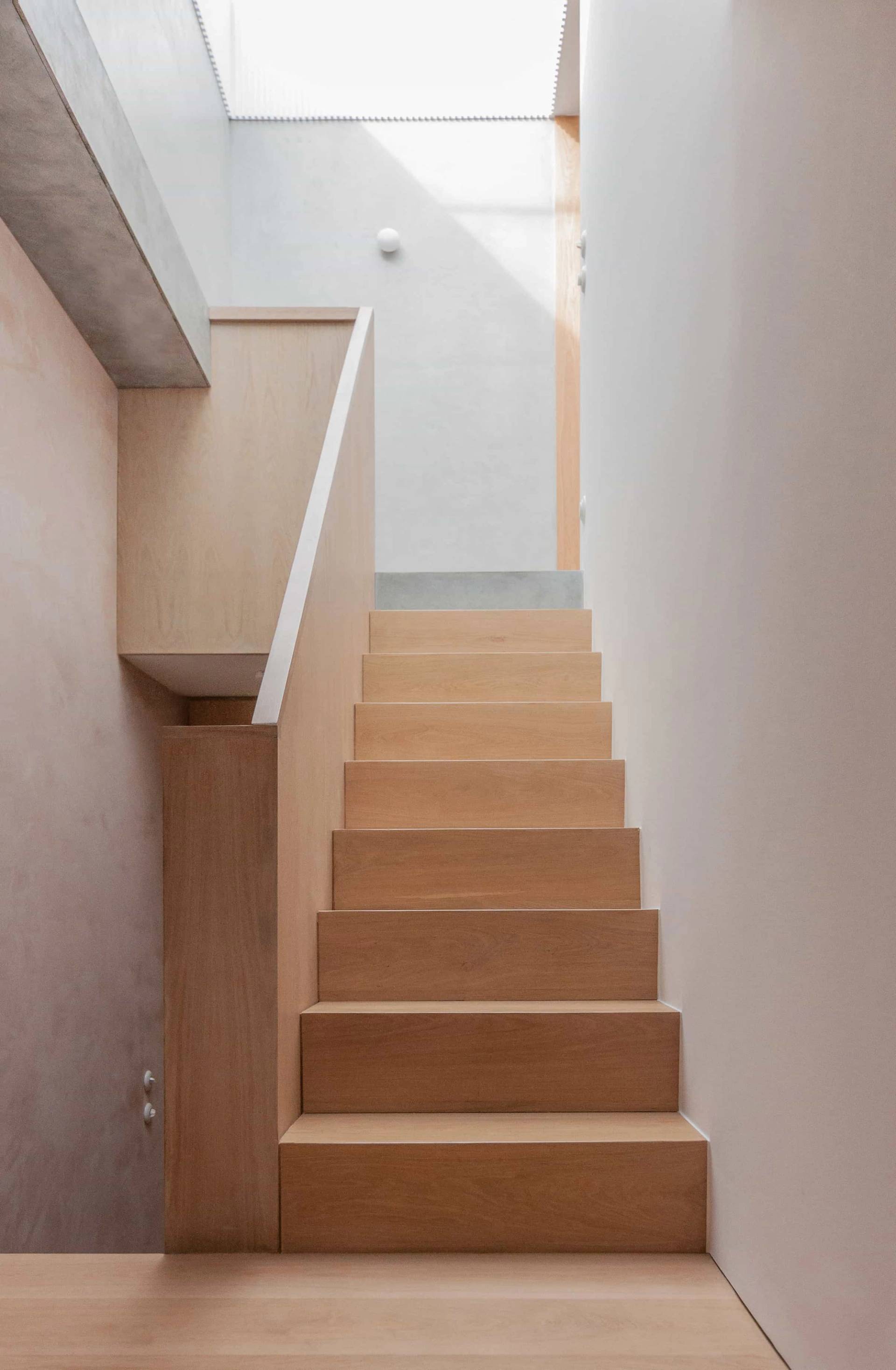 Minimalist wooden staircase shoot location in Hackney London N16 from Love Locations, featuring crisp micro-cement walls and a clean architectural finish.